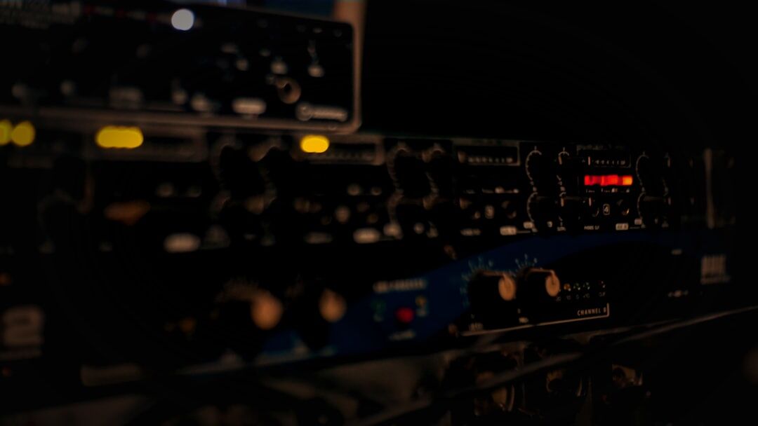 Abstract sound waves and music equipment dark background