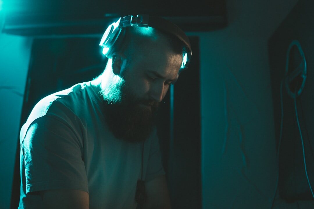 Audio engineer working on mixing console with headphones